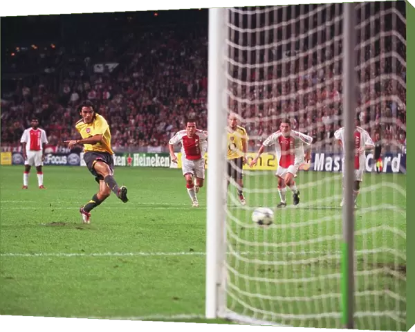 Robert Pires shoots past Ajax goalkeeper Hans Vonk to score the 2nd Arsenal goal from the penalty sp