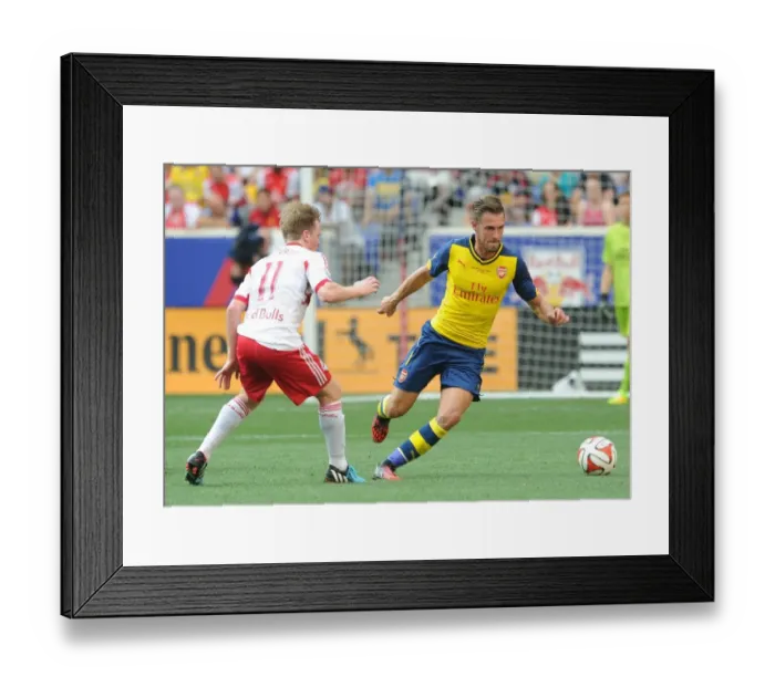 Framed Print : Arsenal's Aaron Ramsey Outmaneuvers Dax McCarty in New York Red Bulls Pre-Season Clash