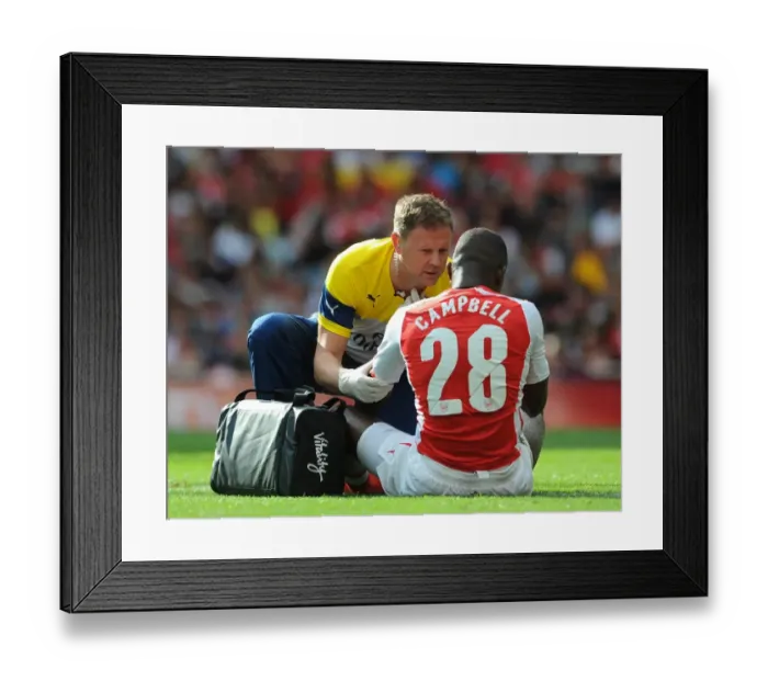 Framed Print : Colin Lewin the Arsenal Physio treats Joel Campbell (Arsenal). Arsenal 5: 1 Benfica Framed Print : Colin Lewin the Arsenal Physio treats Joel Campbell (Arsenal). Arsenal 5: 1 Benfica
