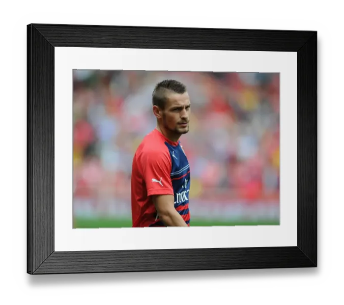 Framed Print : Arsenal's Mathieu Debuchy Prepares for Arsenal v Benfica at Emirates Stadium (2014-15)