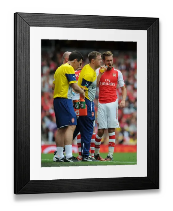 Framed Print : Arsenal Medical Team Tends to Aaron Ramsey During Arsenal v Benfica Match, Emirates Cup 2014-15