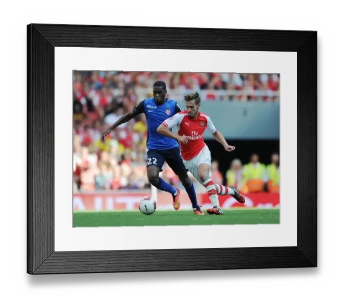 Framed Print : Arsenal's Aaron Ramsey Outmaneuvers AS Monaco's Geoffrey Kondogbia during the Emirates Cup Match Framed Print : Arsenal's Aaron Ramsey Outmaneuvers AS Monaco's Geoffrey Kondogbia during the Emirates Cup Match