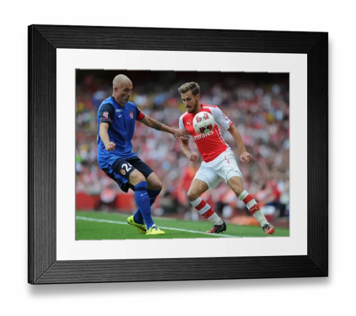 Framed Print : Clash of Champions: Ramsey vs. Raggi - Arsenal's Ramsey Goes Head-to-Head with AS Monaco's Raggi in Thrilling Emirates Cup Encounter
