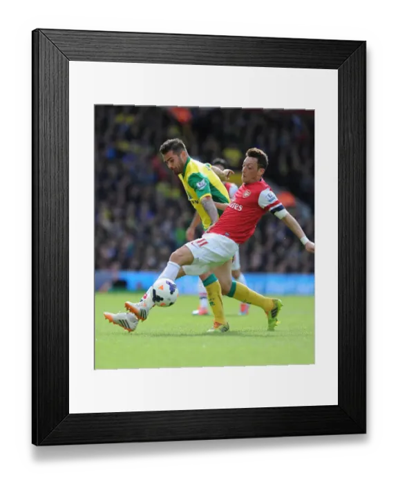 Framed Print : Mesut Ozil vs. Robert Snodgrass: Intense Battle at Carrow Road - Norwich City vs. Arsenal (2013-14)