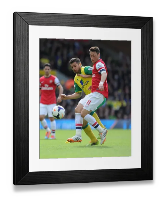 Framed Print : Intense Rivalry: Mesut Ozil vs. Robert Snodgrass Clash at Carrow Road, 2014