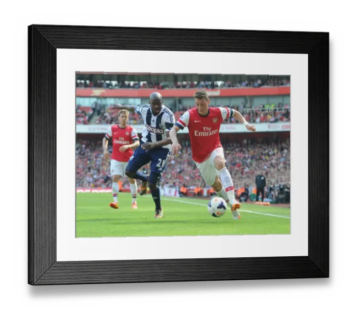 Framed Print : Arsenal's Mesut Ozil Faces Off Against West Brom's Yossouf Mulumbu in 2013-14 Premier League Clash