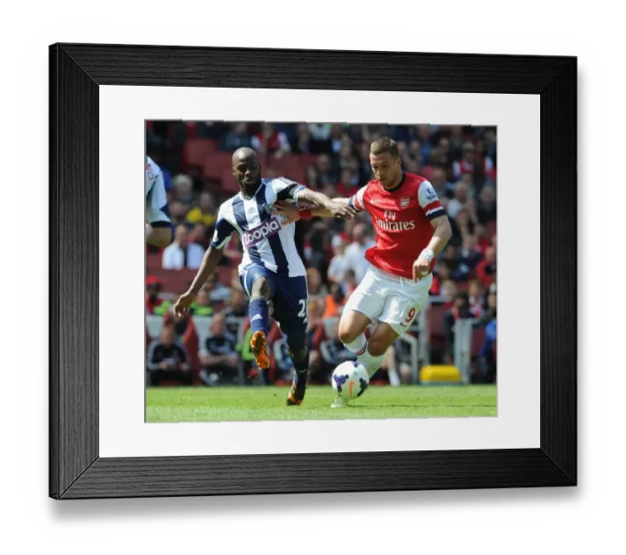 Framed Print : Lukas Podolski (Arsenal) Yousouf Mulumbu (WBA). Arsenal 1: 0 West Bromwich Albion