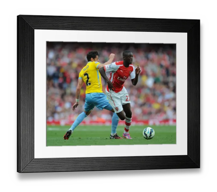 Framed Print : Yaya Sanogo Outwits Joel Ward: Arsenal's Edge in Premier League Clash (August 2014)