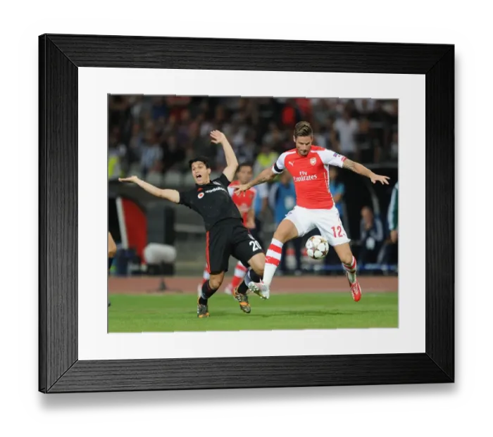 Framed Print : Olivier Giroud Outmaneuvers Necip Uysal in Arsenal's UEFA Champions League Clash vs Besiktas