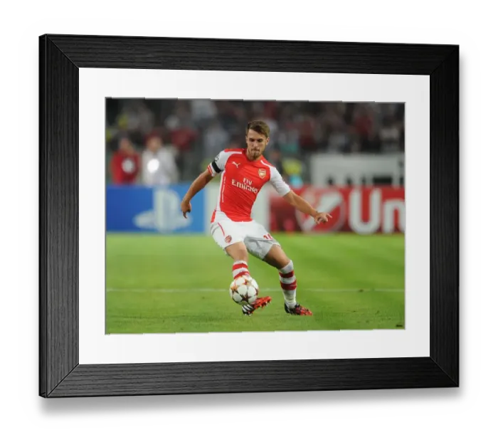 Framed Print : Aaron Ramsey in Action: Arsenal vs. Besiktas, UEFA Champions League Qualifiers 2014