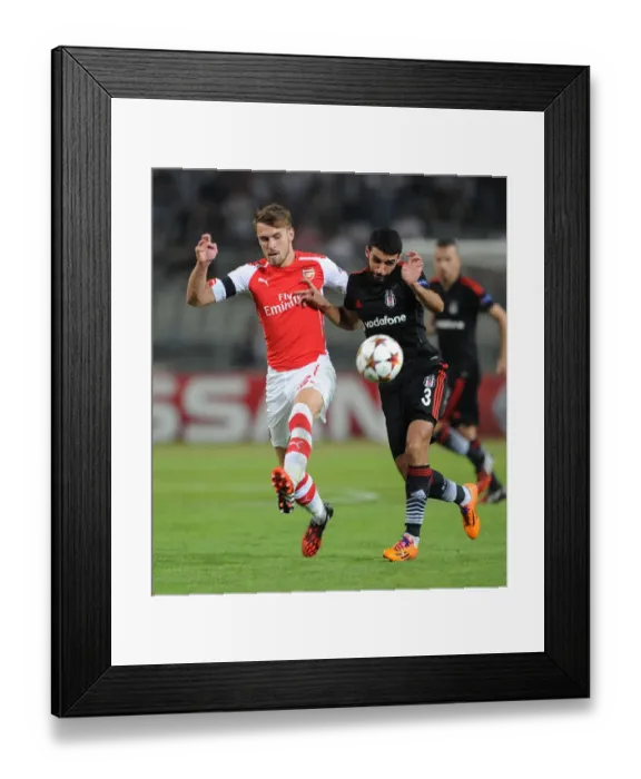 Framed Print : Arsenal's Aaron Ramsey Faces Off Against Besiktas Ismail Koybasi in UEFA Champions League Qualifier Framed Print : Arsenal's Aaron Ramsey Faces Off Against Besiktas Ismail Koybasi in UEFA Champions League Qualifier