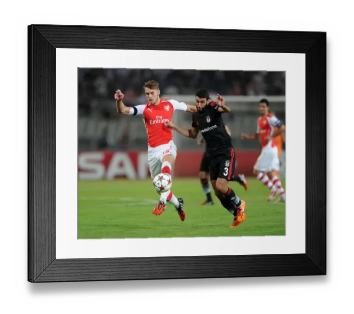 Framed Print : Arsenal's Aaron Ramsey Clashes with Ismail Koybasi of Besiktas in UEFA Champions League Qualifier Framed Print : Arsenal's Aaron Ramsey Clashes with Ismail Koybasi of Besiktas in UEFA Champions League Qualifier