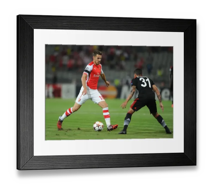 Framed Print : Arsenal's Aaron Ramsey Faces Off Against Ramon Motta in UEFA Champions League Qualifiers (2014): A Battle in Istanbul Framed Print : Arsenal's Aaron Ramsey Faces Off Against Ramon Motta in UEFA Champions League Qualifiers (2014): A Battle in Istanbul