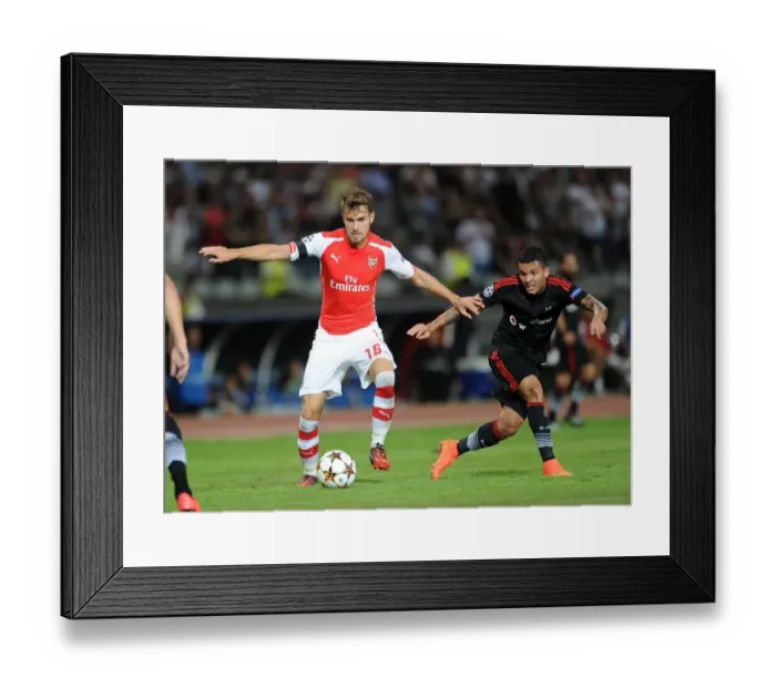 Framed Print : Clash of Midfield Titans: Aaron Ramsey vs. Ramon Motta in Arsenal's UEFA Champions League Showdown against Besiktas Framed Print : Clash of Midfield Titans: Aaron Ramsey vs. Ramon Motta in Arsenal's UEFA Champions League Showdown against Besiktas