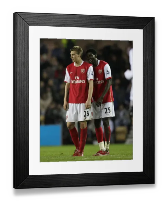 Framed Print : Emmanuel Adebayor (Arsenal) shares a joke with Nicklas Bendtner