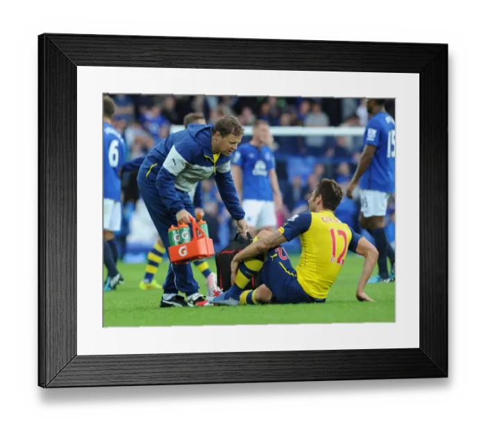Framed Print : Arsenal's Colin Lewin Tends to Injured Olivier Giroud vs Everton (2014 / 15)