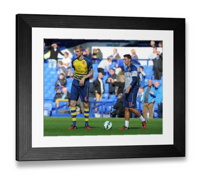 Framed Print : Arsenal Stars Mesut Ozil and Per Mertesacker Warm Up Ahead of Everton Clash (2014 / 15) Framed Print : Arsenal Stars Mesut Ozil and Per Mertesacker Warm Up Ahead of Everton Clash (2014 / 15)