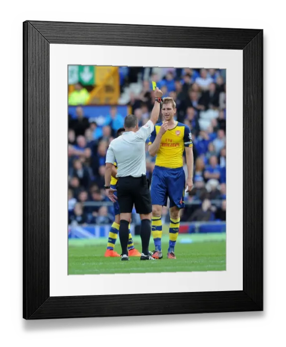 Framed Print : Per Mertesacker Shown Yellow Card in Everton vs. Arsenal Premier League Clash (2014 / 15)