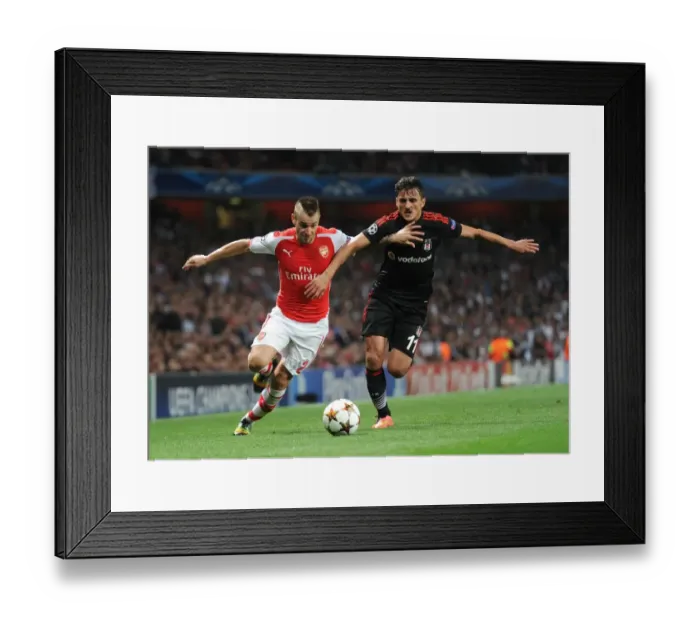 Framed Print : Arsenal's Debuchy Clashes with Besiktas Pektemek in Champions League Showdown Framed Print : Arsenal's Debuchy Clashes with Besiktas Pektemek in Champions League Showdown
