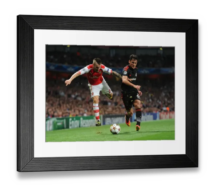 Framed Print : Arsenal's Debuchy Clashes with Besiktas Pektemek in UEFA Champions League Qualifier