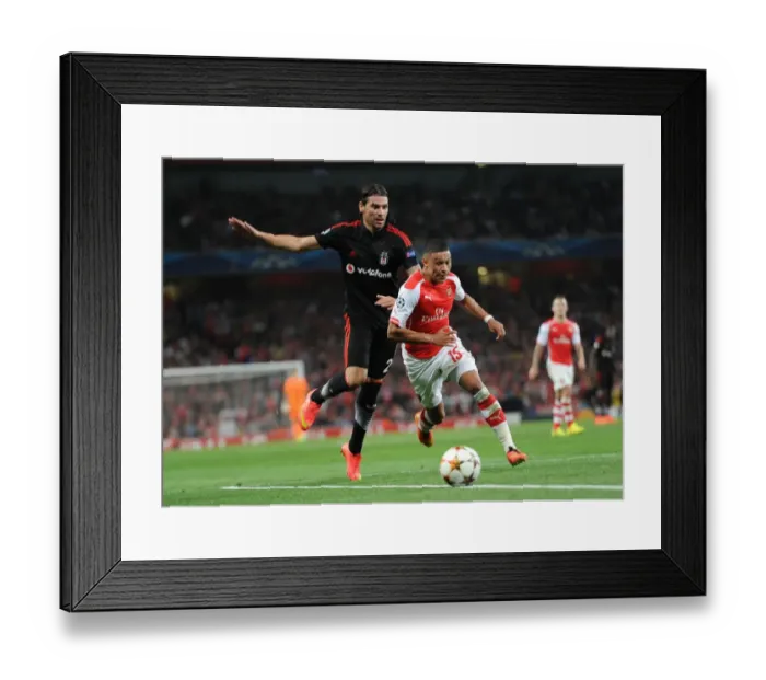 Framed Print : Arsenal's Alex Oxlade-Chamberlain Faces Off Against Besiktas Ersan Gulum in Champions League Clash Framed Print : Arsenal's Alex Oxlade-Chamberlain Faces Off Against Besiktas Ersan Gulum in Champions League Clash