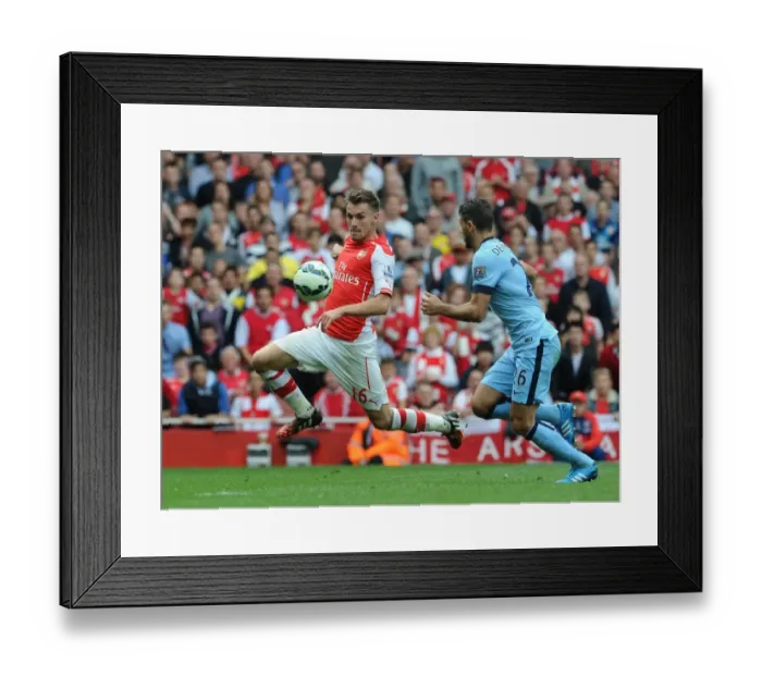 Framed Print : Arsenal's Aaron Ramsey Faces Off Against Manchester City's Martin Demichelis in Intense Premier League Clash Framed Print : Arsenal's Aaron Ramsey Faces Off Against Manchester City's Martin Demichelis in Intense Premier League Clash