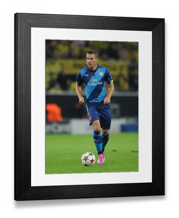 Framed Print : Lukas Podolski: A Battle Against Former Team in Borussia Dortmund vs Arsenal, UEFA Champions League (2014-2015)