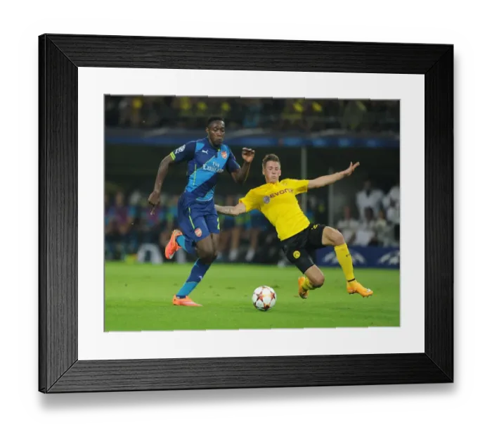 Framed Print : Danny Welbeck vs. Eric Durm: A Battle in the UEFA Champions League between Borussia Dortmund and Arsenal