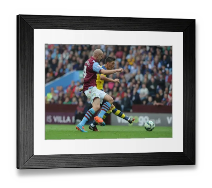 Framed Print : Mesut Ozil Scores First Arsenal Goal of the Season Against Aston Villa Amidst Philippe Senderos Pressure (2014-15) Framed Print : Mesut Ozil Scores First Arsenal Goal of the Season Against Aston Villa Amidst Philippe Senderos Pressure (2014-15)