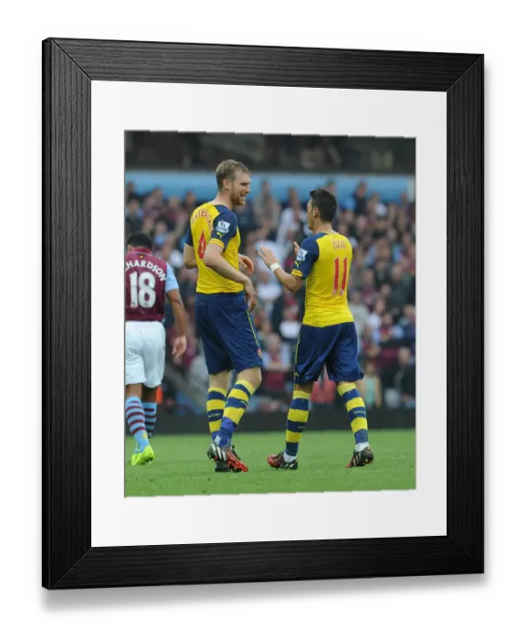 Framed Print : Mesut Ozil and Per Mertesacker Celebrate Arsenal's First Goal Against Aston Villa (2014-15) Framed Print : Mesut Ozil and Per Mertesacker Celebrate Arsenal's First Goal Against Aston Villa (2014-15)