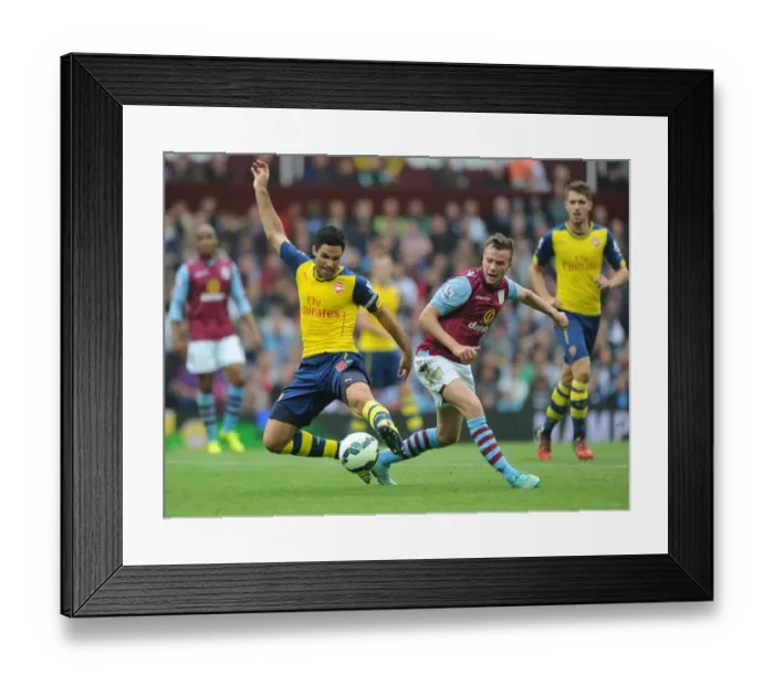Framed Print : Mikel Arteta vs Tom Cleverly: Intense Clash in Aston Villa vs Arsenal Premier League Match, 2014