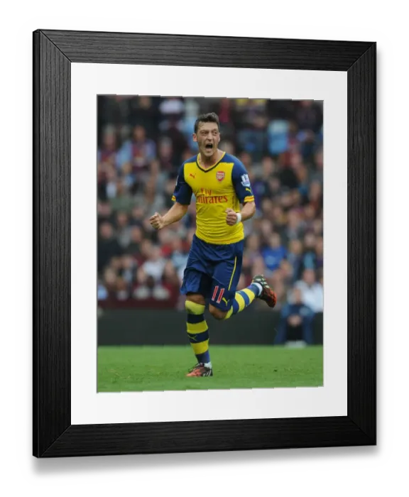 Framed Print : Mesut Ozil's Triumph: Scoring First Goal for Arsenal Against Aston Villa in Premier League 2014-15