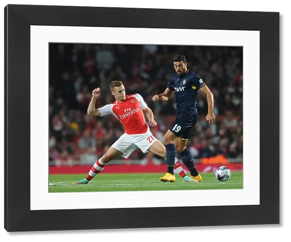 Clash at the Emirates: Chambers vs. Pelle in the League Cup Battle