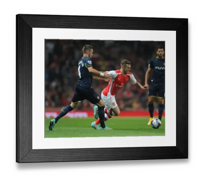 Framed Print : Arsenal's Jack Wilshere Faces Off Against Southampton's Morgan Schneiderlen in League Cup Clash