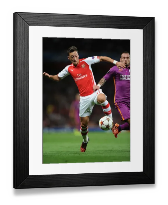 Framed Print : Arsenal FC vs Galatasaray AS: Mesut Ozil in Champions League Action at Emirates Stadium