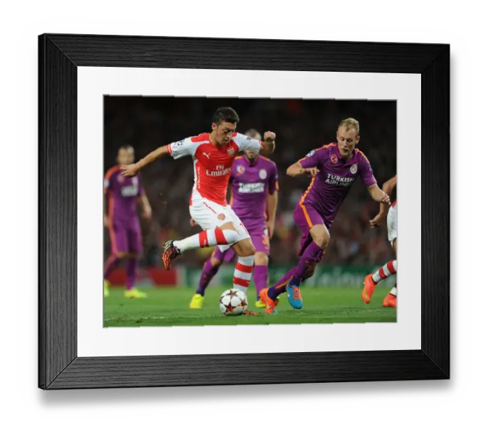 Framed Print : Mesut Ozil Breaks Past Galatasaray's Samih Kaya in Arsenal's 2014 / 15 Champions League Clash Framed Print : Mesut Ozil Breaks Past Galatasaray's Samih Kaya in Arsenal's 2014 / 15 Champions League Clash