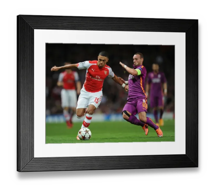 Framed Print : Champions League Showdown: Oxlade-Chamberlain vs. Sneijder - Arsenal vs. Galatasaray: A Battle of Midfield Maestros
