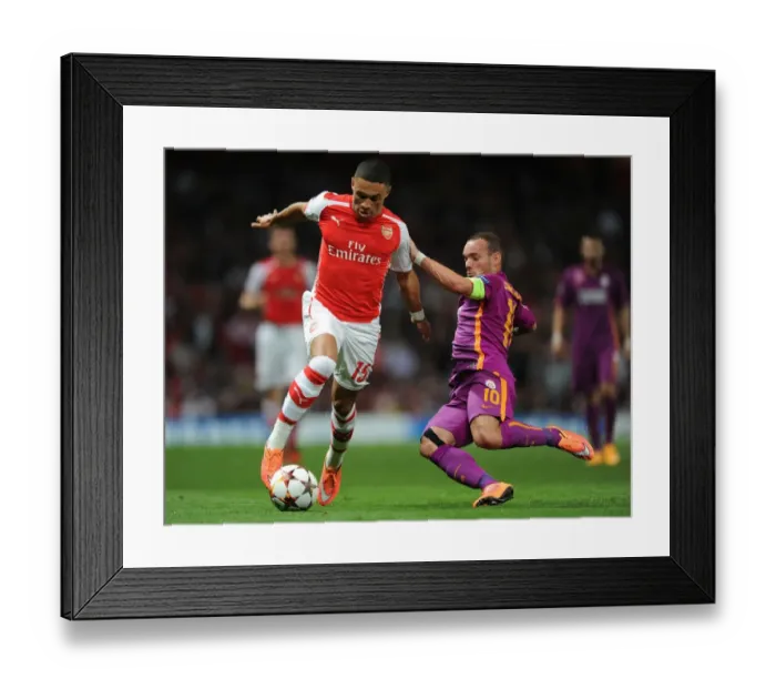 Framed Print : Champions League Showdown: Oxlade-Chamberlain vs. Sneijder - Arsenal's Midfield Maestros Battle it Out against Galatasaray