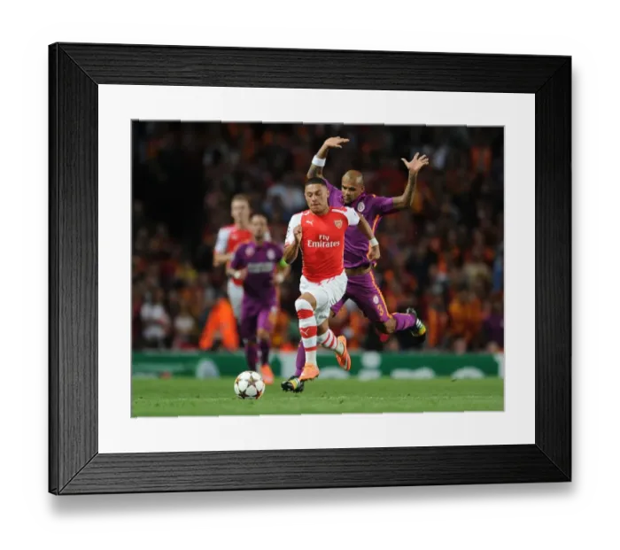 Framed Print : Arsenal's Oxlade-Chamberlain Clashes with Galatasaray's Felipe Melo in Champions League Showdown Framed Print : Arsenal's Oxlade-Chamberlain Clashes with Galatasaray's Felipe Melo in Champions League Showdown