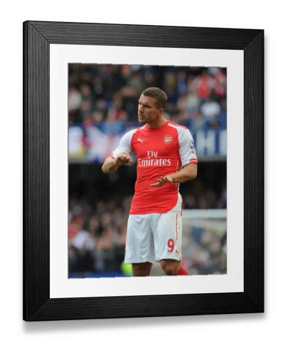 Framed Print : Arsenal's Podolski Faces Off Against Chelsea at Stamford Bridge (2014-15 Premier League)