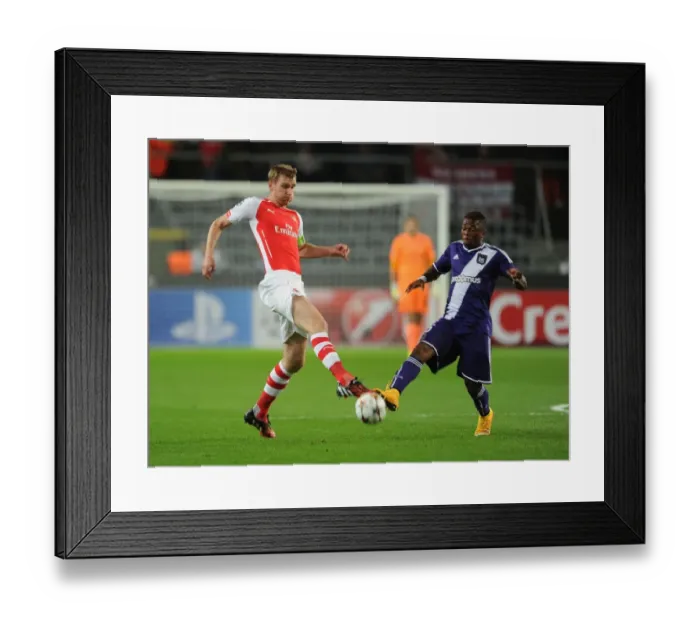 Framed Print : Per Mertesacker vs Cyriac: Intense Battle in Anderlecht v Arsenal UEFA Champions League Clash Framed Print : Per Mertesacker vs Cyriac: Intense Battle in Anderlecht v Arsenal UEFA Champions League Clash