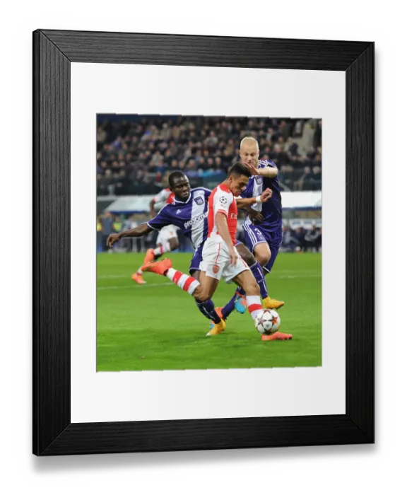 Framed Print : Arsenal's Alexis Sanchez Faces Off Against Anderlecht Defenders Olivier Deschacht and Frank Acheampong