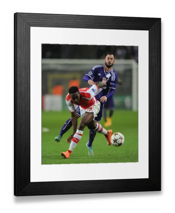 Framed Print : Danny Welbeck vs. Steven Defour: Intense Battle in Arsenal's UEFA Champions League Clash with Anderlecht