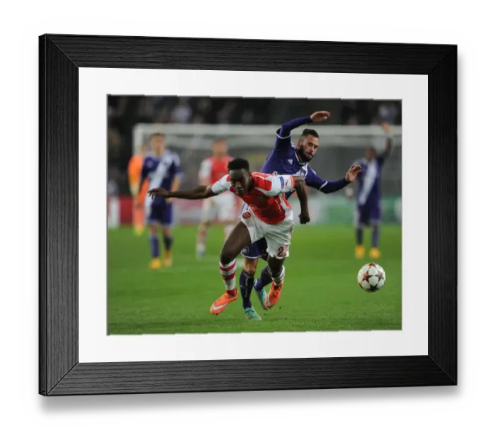 Framed Print : Intense Battle: Welbeck vs. Defour - Arsenal's UEFA Champions League Showdown