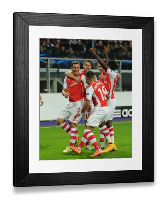 Framed Print : Arsenal's Lukas Podolski Scores and Celebrates with Teammates against RSC Anderlecht in UEFA Champions League, 2014