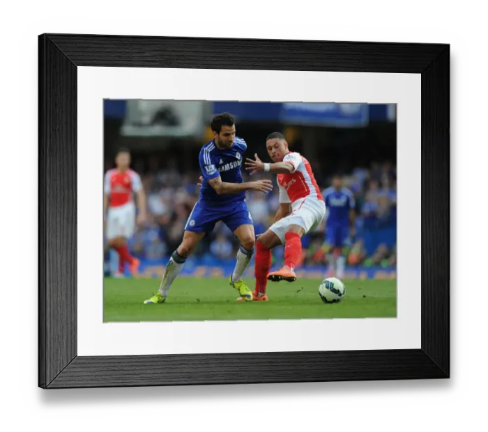 Framed Print : Clash of the Midfield Maestros: Oxlade-Chamberlain vs. Fabregas - A Premier League Battle