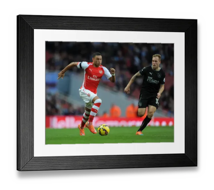 Framed Print : Intense Face-Off: Alex Oxlade-Chamberlain vs Scott Arfield at Emirates Stadium