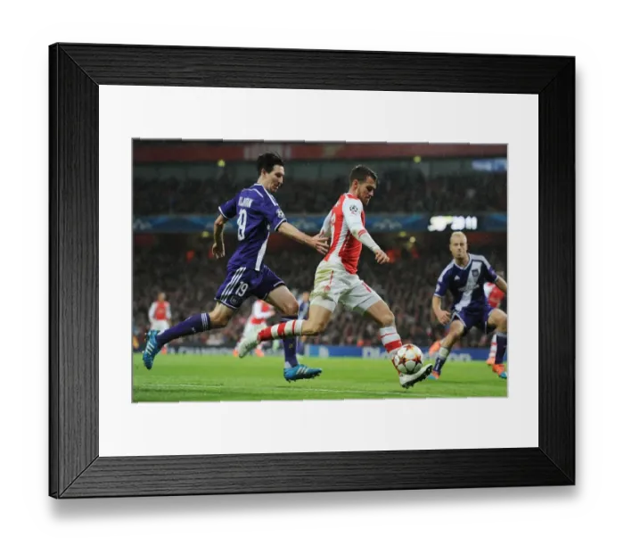 Framed Print : Arsenal's Aaron Ramsey Outmaneuvers Sacha Kljestan in Champions League Clash