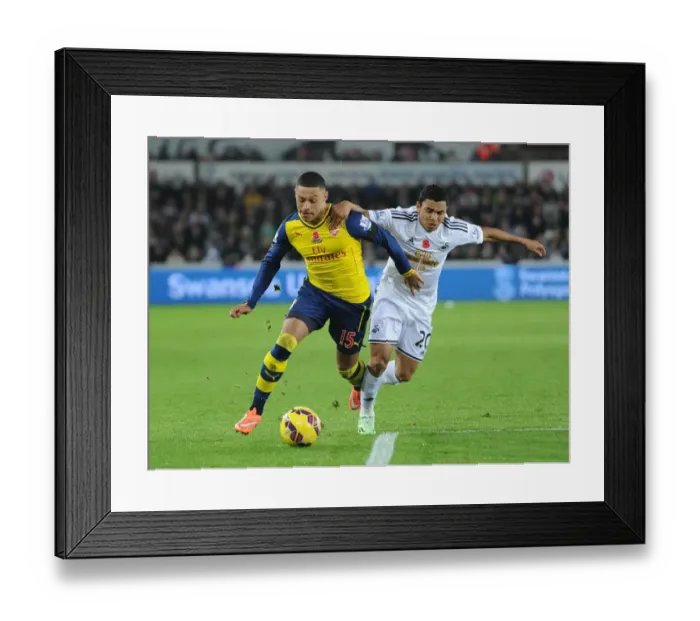 Framed Print : Clash of Wings: Oxlade-Chamberlain vs Montero in Swansea v Arsenal (2014-15)