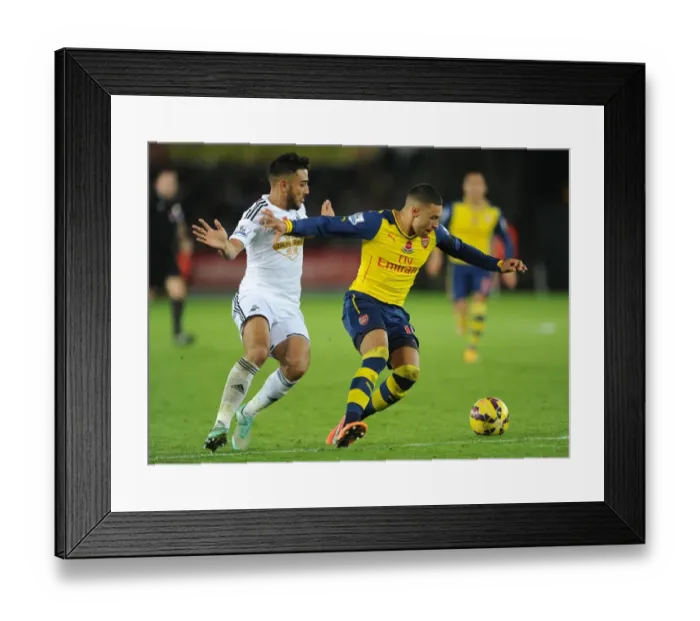 Framed Print : Arsenal's Alex Oxlade-Chamberlain Fends Off Swansea's Neil Taylor Framed Print : Arsenal's Alex Oxlade-Chamberlain Fends Off Swansea's Neil Taylor